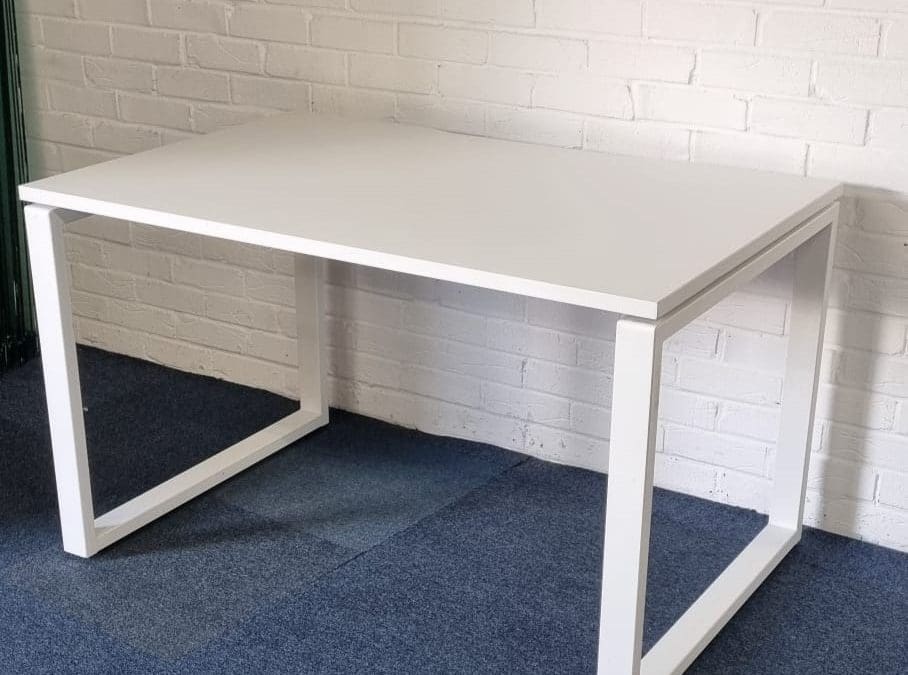 A modern office setting featuring a sit-stand desk with a happy employee transitioning between sitting and standing